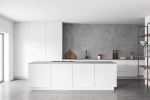 Interior of modern kitchen with white and concrete walls, concrete floor and white island. Cupboards with built in sink and cooker. 3d rendering